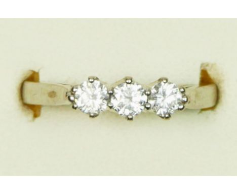 An 18ct white gold and three stone brilliant cut diamond ring, stated weight 0.50cts, colour estimate G/H, clarity estimate V