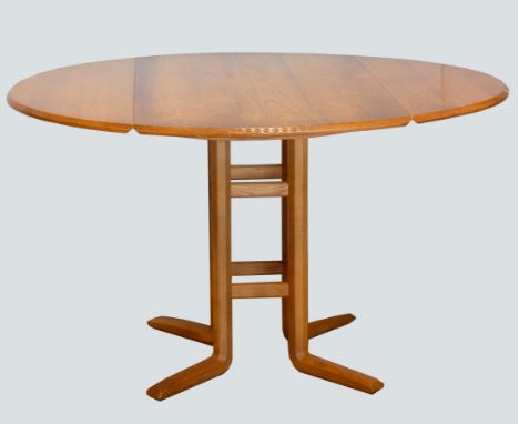 An Ercol light oak drop-leaf dining table, raised on a central pedestal with spayed feet.123x112 extended, unextended 112x61c