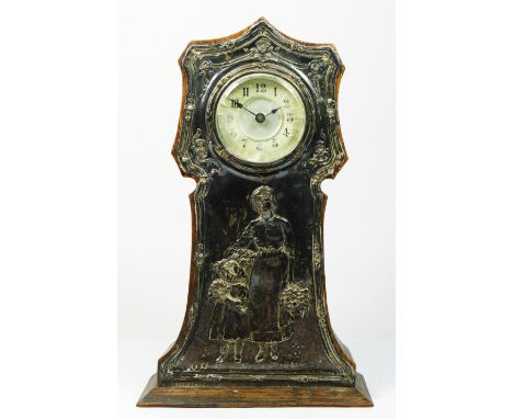 An Edwardian silver and oak mantle time piece, Birmingham 1905, the front with an embossed panel depicting a mother and daugh