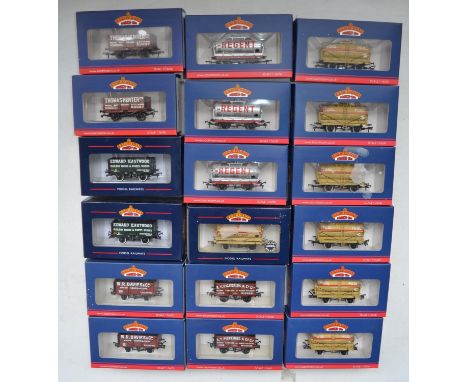 Eighteen Bachmann OO gauge railway wagons to include 7 plank end door wagons, 14 ton tank wagons etc. Contents appear mint, b