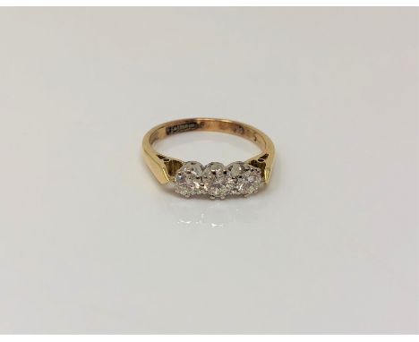 An 18ct gold three stone diamond ring, size K CONDITION REPORT: 2.6g