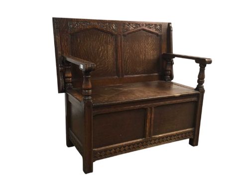 CARVED OAK MONK'S BENCH, with hinged lid98cm x 108cmWooden dowels holding the top in place have been replaced with screws, se
