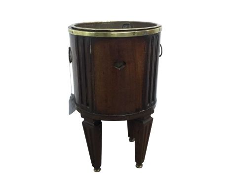 VICTORIAN MAHOGANY PLANTER, 19TH CENTURY  of cylindrical form with twin brass handles, raised on tapered legs, terminating on