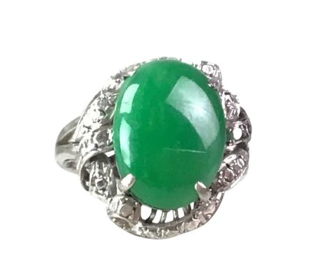 JADE RING, set with cabochon jade, marked 18KGenerally worn condition, scratches and small dents to the side of the ring, no 