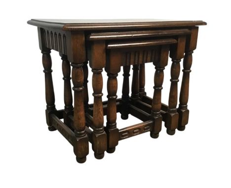 OAK NEST OF THREE TABLES, AND A TILE TOPPED NEST OF TABLES the oak nest with turned supports oak nest 61cm wideQty: 2