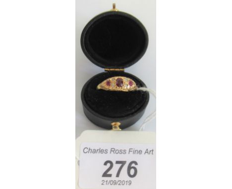 A ruby and diamond yellow metal ladies dress ring.