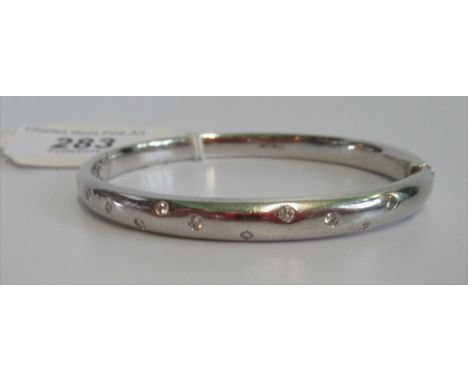 A diamond set 18 carat white gold bangle, the front set with eleven brilliant cut diamonds. Condition Report: Weight = 32.3 g