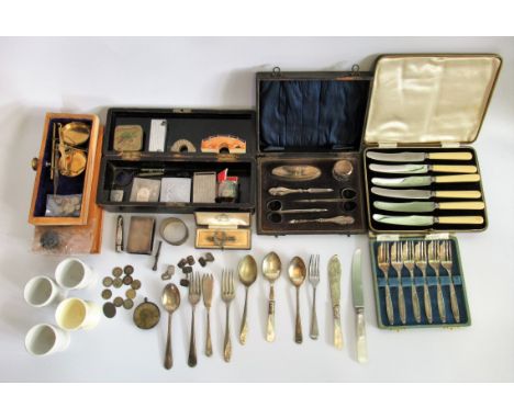 A box containing a quantity of miscellaneous items, to include: silver plated cake forks, postal scales, egg cups, various ha