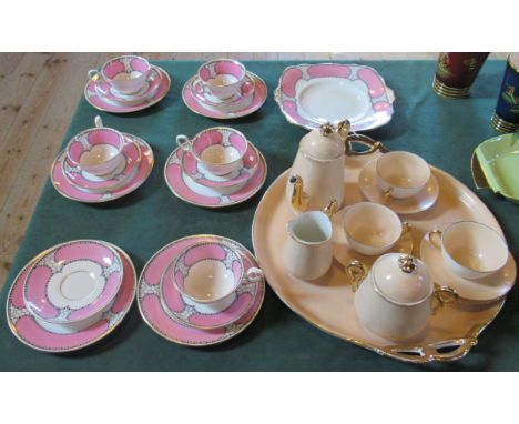 A G.D &amp; Co., Limoges afternoon tea set, comprising: teapot, twin handled sugar bowl, milk jug, cups and saucers, on a twi