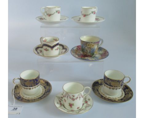 A collection of 7 miscellaneous decorated coffee cans and saucers.