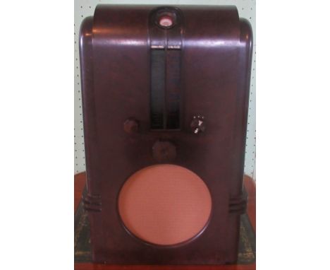 An Ekco AC97 model radio. Condition Report: Overall condition good.  Small patch repair to top.  No cracks or major damage.