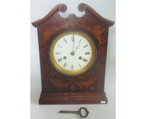 An Edwardian mahogany and inlaid mantle clock.