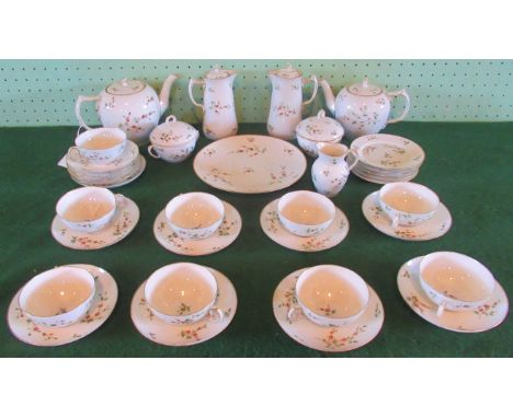 A Royal Copenhagen tea service, with gilt rim and flower decoration, comprising: tea and coffee pots, hot water jugs, sugar b
