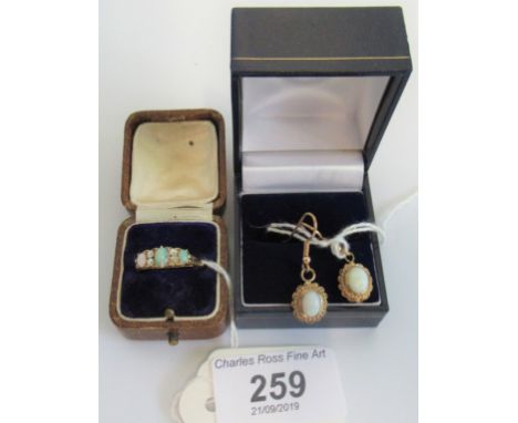 An opal and diamond set ring, together with a matching pair of earrings. Condition Report: No hallmarks.  7.3 grams gross.  C