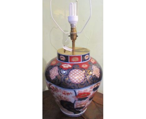 An Imari table lamp, decorated in the Oriental palette, with cream shade.