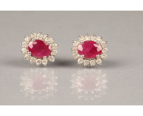 Pair of eighteen carat white gold ruby and diamond earrings, diamonds approximately 0.5 carats, ruby weight 1.3 carats