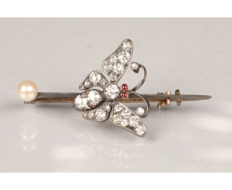 Diamond butterfly brooch, set with old cut diamonds and ruby eyes mounted to an unmarked pin with a mounted pearl, length 47m