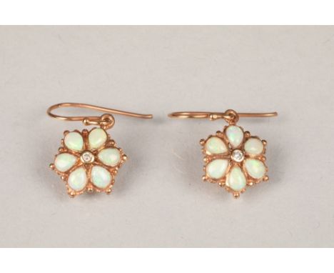 Pair of opal cluster drop earrings, daisy form, six teardrop opals with a central diamond to each earring, 8mm diameter