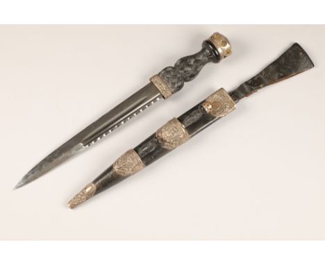 Scottish dirk and scabbard, with an embossed silver thistle mounts, assay marked Edinburgh 1918, unmarked 29.5cm polished bla