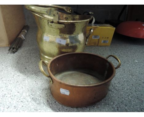A brass coal helmet and copper pan