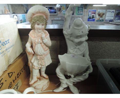 A ceramic planter in the form of a seated clown and a figurine of a young girl 