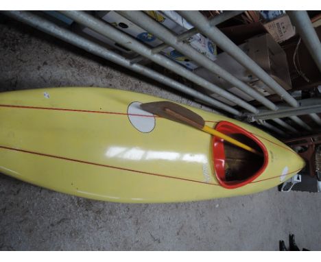 A vintage slalom canoe/kayak and paddle