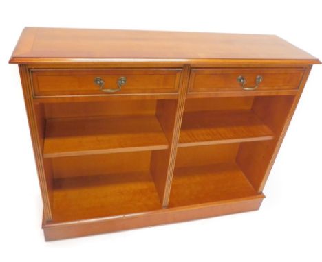 A yew open bookcase, the crossbanded top with a moulded edge above two short drawers and a shelf, on plinth base, 83cm H, 106