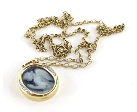 A 9ct gold pendant and chain,  the oval pendant set with a blue and white cameo design of an angel, with tiny cz set surround