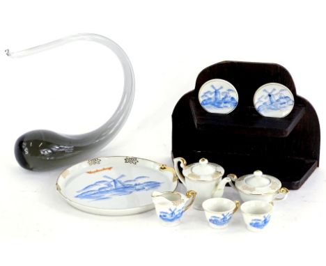A Wedgwood glass tadpole shaped paperweight, and a Dutch porcelain miniature tea service with tray.