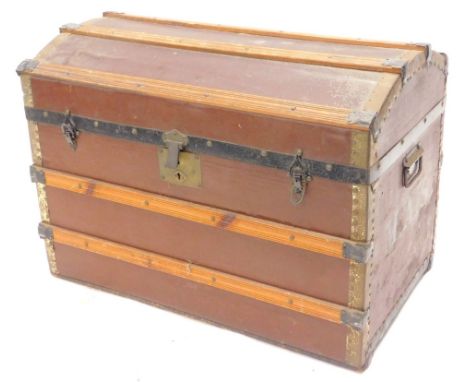An early 20thC canvas and wooden dome top trunk, with side carrying handles, 77cm W.