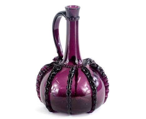 A continental amethyst tinted glass flask, with trail decoration to the sides and plain handle, 22cm H.