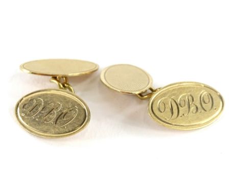 A pair of 9ct gold oval cufflinks, bearing the initials DBO, with engine turned decoration to the other side, 7g.