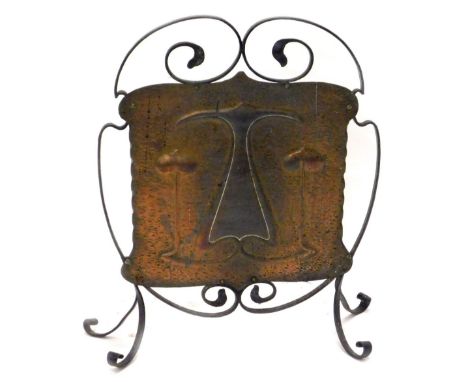 A late 19thC wrought iron and brass Art Nouveau fire screen, decorated with stylised tulips on three scroll shaped feet, 56cm