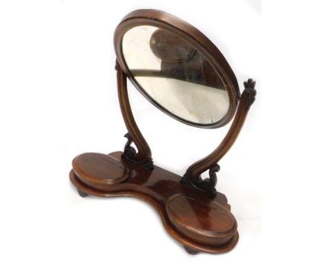 A Victorian mahogany swing frame dressing table mirror, with oval plate on shaped supports, the base with two hinged trinket 