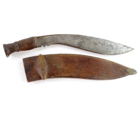 A First World War military Kukri, the curved blade stamped 1918 and with a hardwood handle, the leather scabbard and blade st