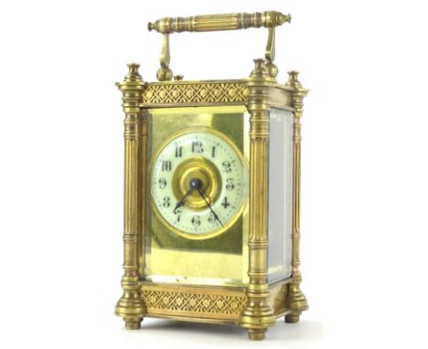 A late 19thC French gilt brass carriage timepiece, the enamel dial with Arabic numerals, the case decorated with blind fret f