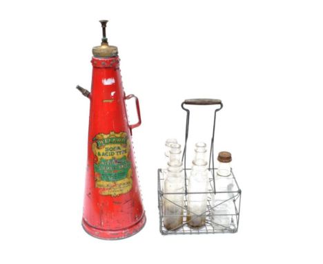 A Vintage Metal Forecourt Oil Bottle Carrier, with wooden handle and two glass Essolube oil bottles, a Castrol oil bottle wit
