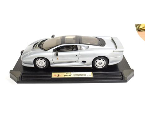 Maisto: A Metal Scale Model of a Jaguar XJ220, 1992, mounted on a plastic display board, 47cm by 26cm