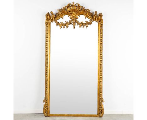 A mirror, sculptured wood, and stucco in a Louis XV style.First half of the 20th century.&nbsp;Dimensions: (W:110 x H:218 cm)