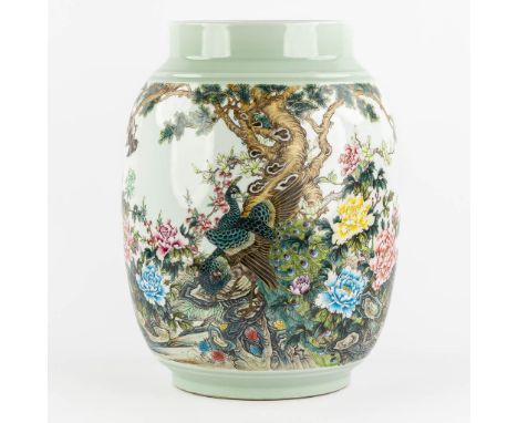 A large Chinese vase with a decor of fauna and flora.&nbsp;Celadon porcelain with a hand-painted decor, depicting a garden sc