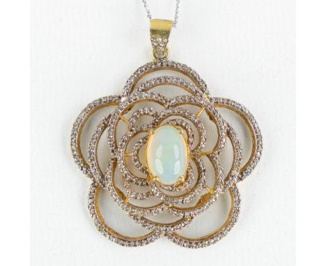 A necklace with pendant, gilt silver with a Caobochon Opal and old cut diamonds, on a 14-kt white gold chain.Total gross weig