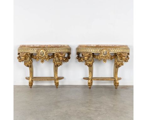 A pair of console tables with ram's heads, Louis XVI style, Italy, 19th C.Sculptured wood, patinated and gilt. Further finish