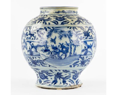 A large Chinese vase, blue-white decorated with fauna and flora.&nbsp;Condition report: The vase has a large yellowed restora