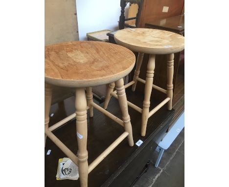 A pair of light wood bar stools. 