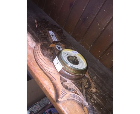 A small wooden carved barometer 