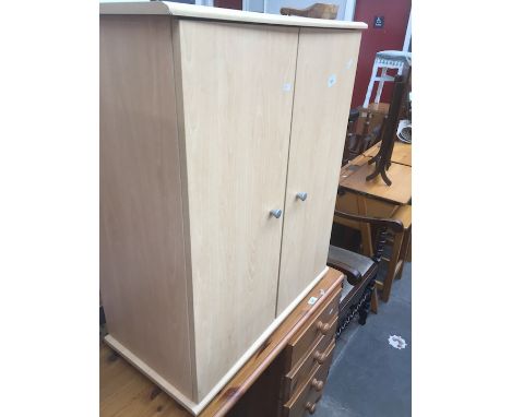 A light wood veneered cabinet. 