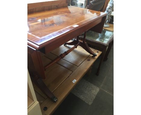 A reproduction yew wood sofa table. 