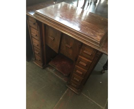 A vintage Singer treadle sewing machine in a cabinet. 