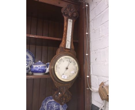 An oak aneroid barometer and another. 