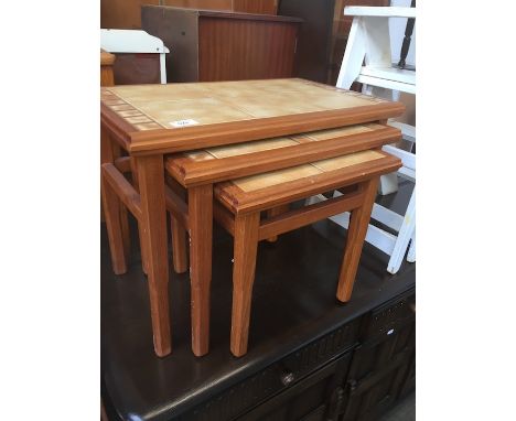 A retro teak and tile top nest of tables. 